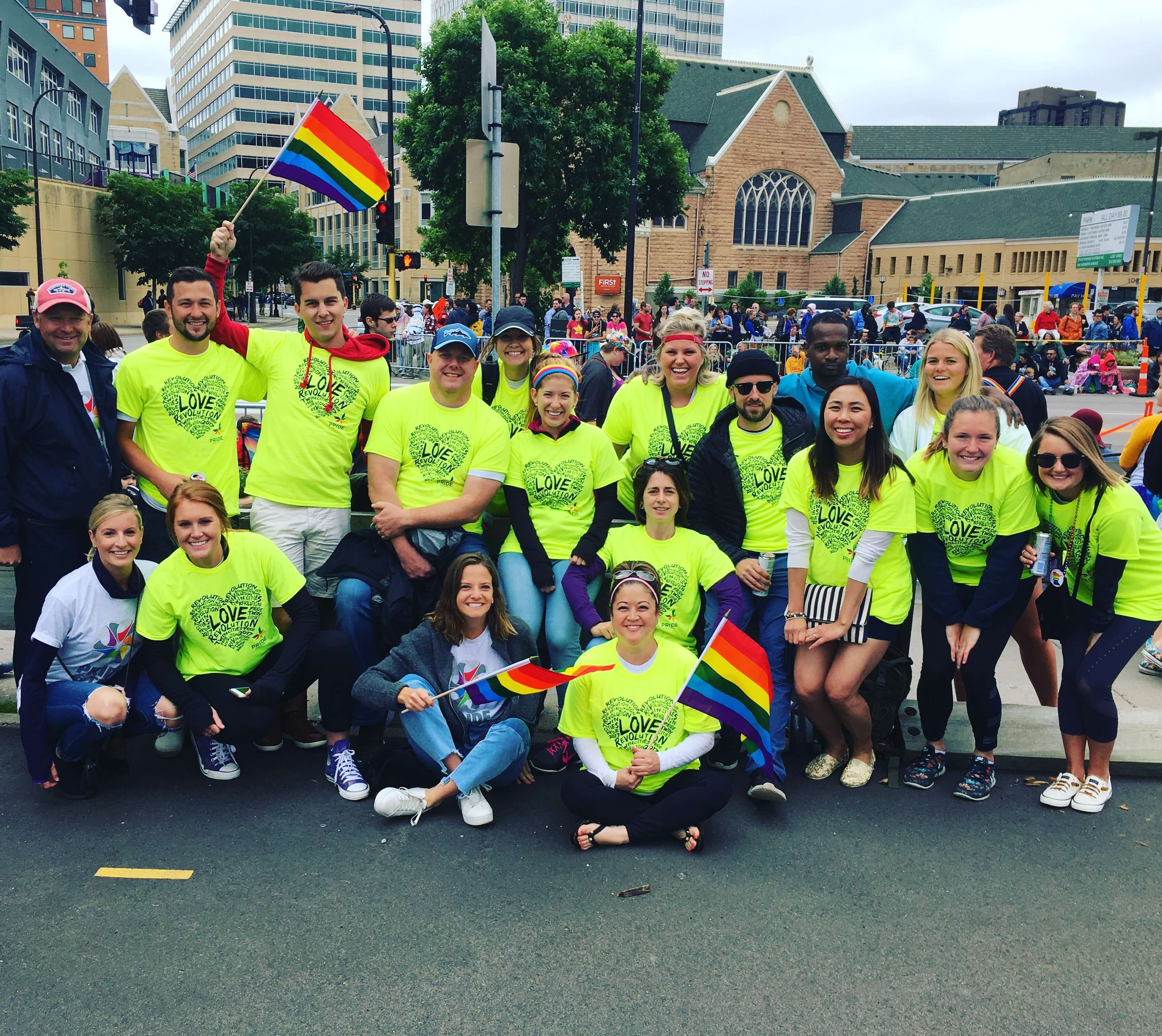 Jordan Dahlheimer (standing, third from left) volunteers at Minneapolis Pride with his office in 2017.