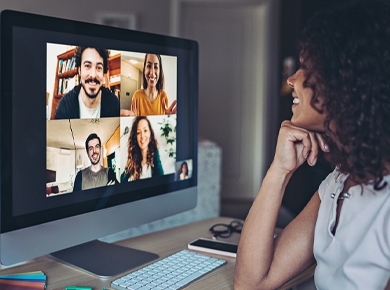 woman with curly hair engaging in a web conference meeting with four collegues