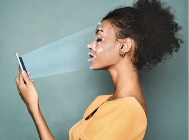 Biometric identification. African-american woman engaging with facial recognition system on smartphone