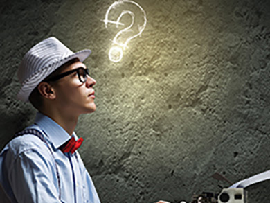 male wearing a hat and bowtie sitting at typewriter with a glowing question mark