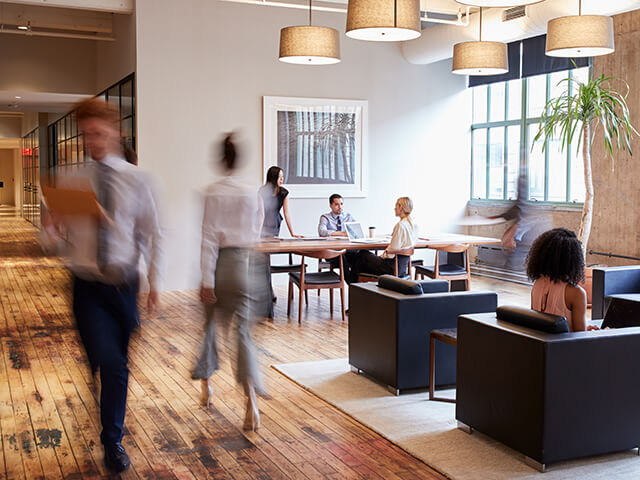 modern office lobby with employees walking by