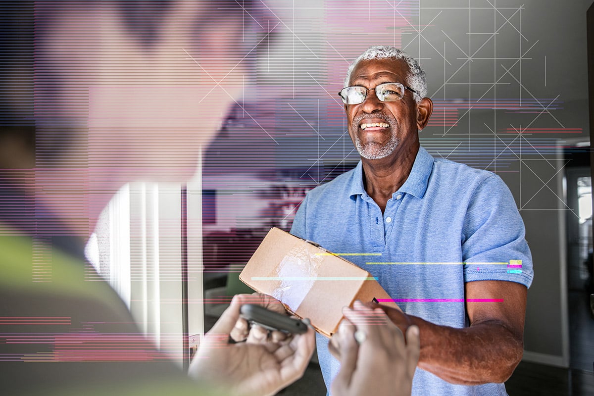 older smiling man receiving package delivery on time thanks to smart data strategies by the carrier