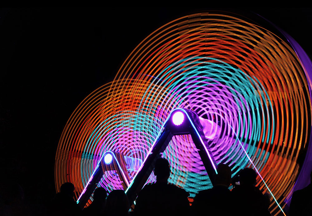 People standing in front of circles of light