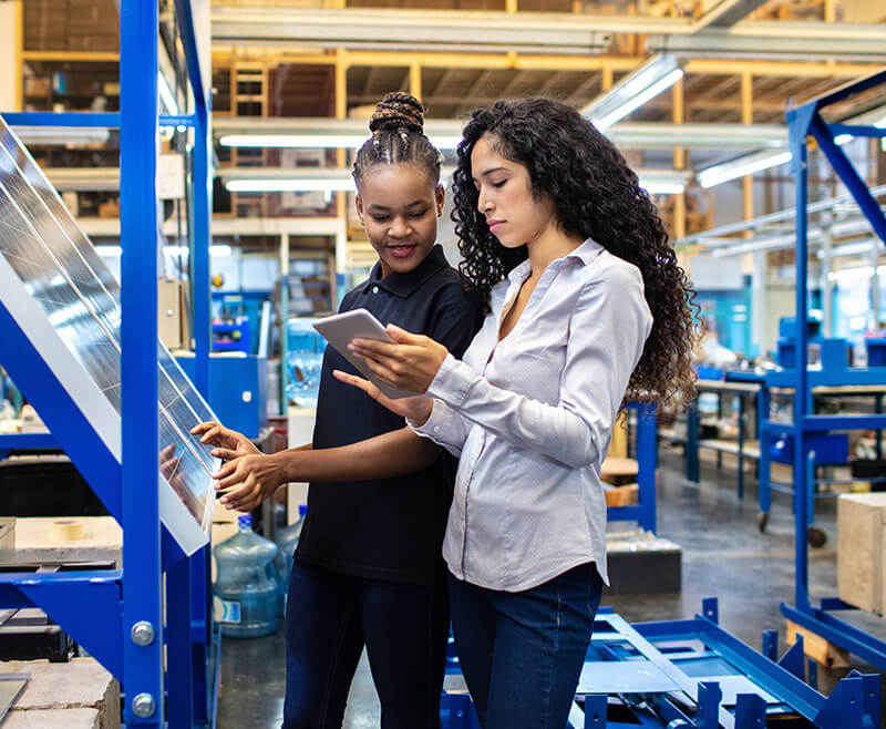two women in a hardware store looking at building materials