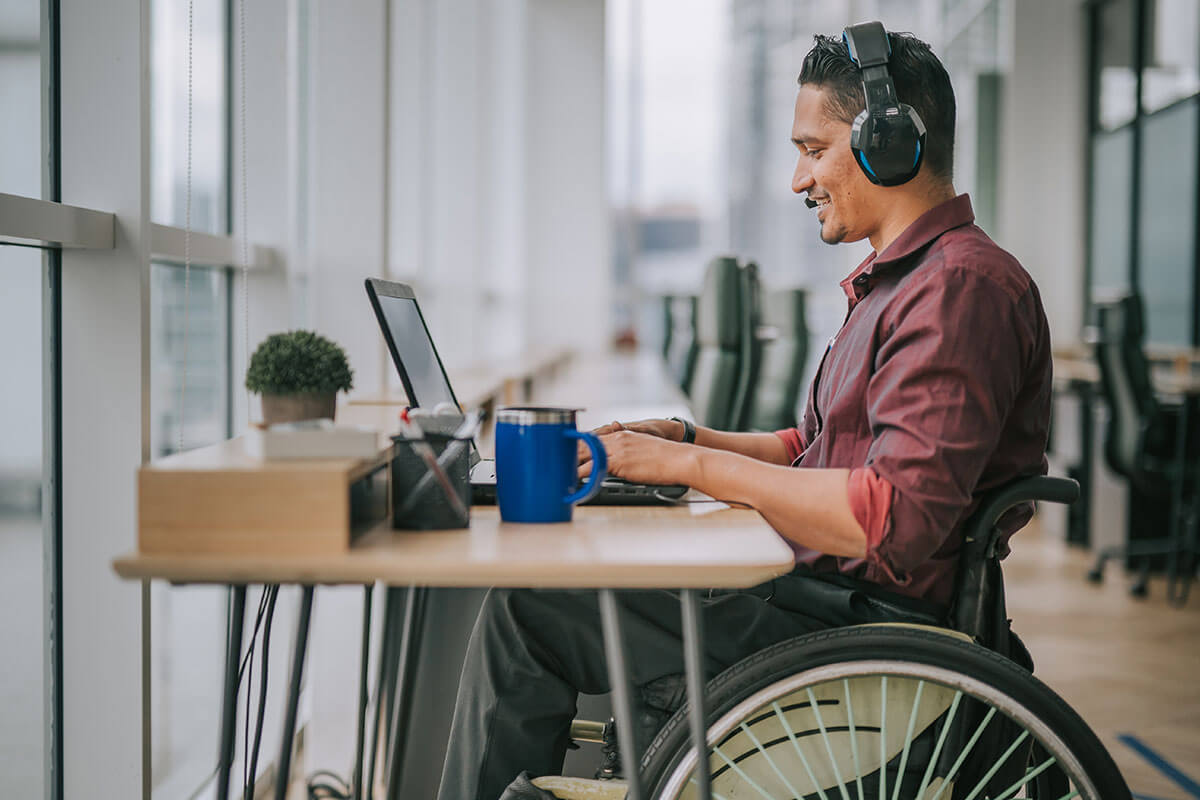 man in wheelchair working in IT