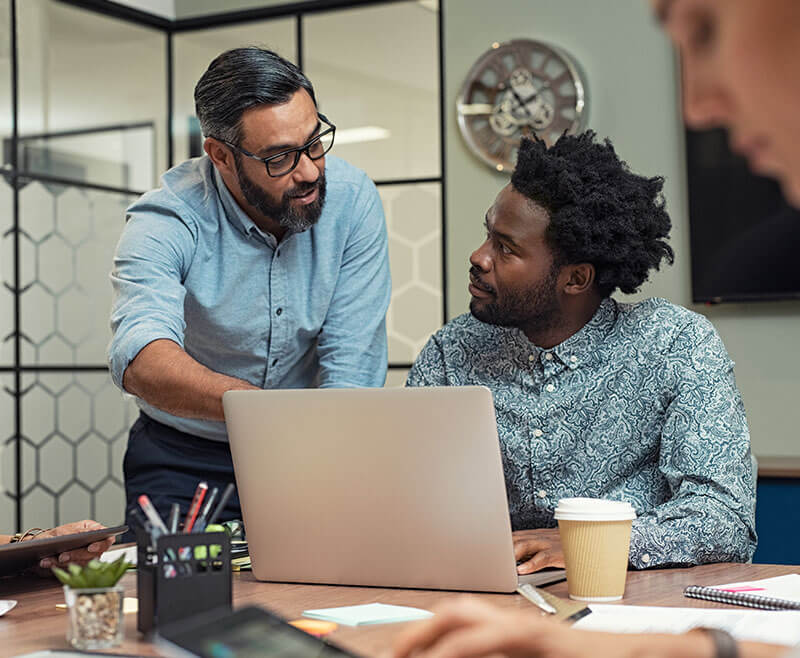 two men talking in inclusive workplace