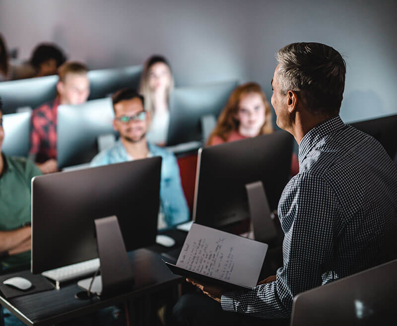 teacher guiding the new IT workforce