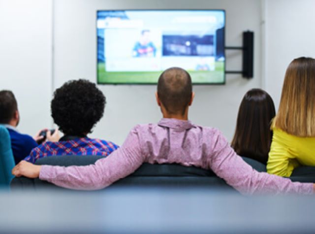 friends watching comcast televisions together