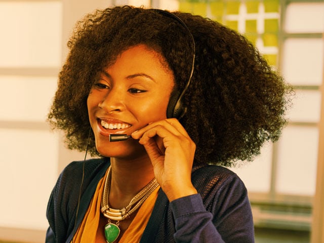A woman on an end user support call on her headset