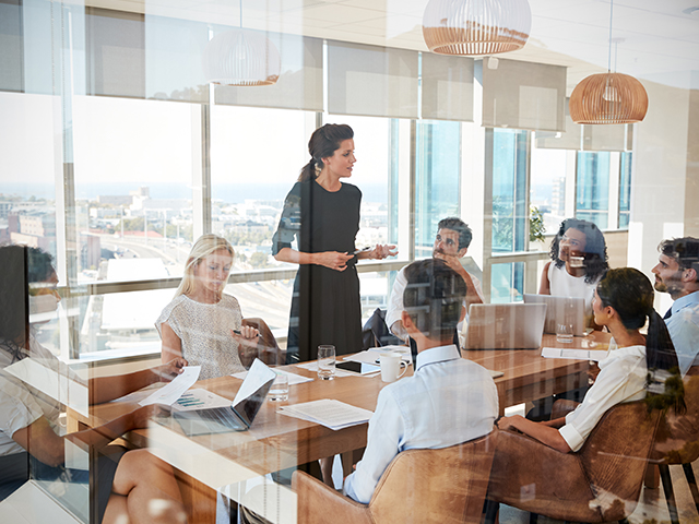 conference room meeting viewed through a glass door.