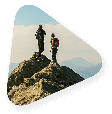 Man and woman on top of a mountain taking their next careers to new heights