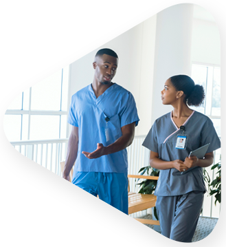 Two healthcare workers discussing completion of an learning solutions collaboration with TEKsystems