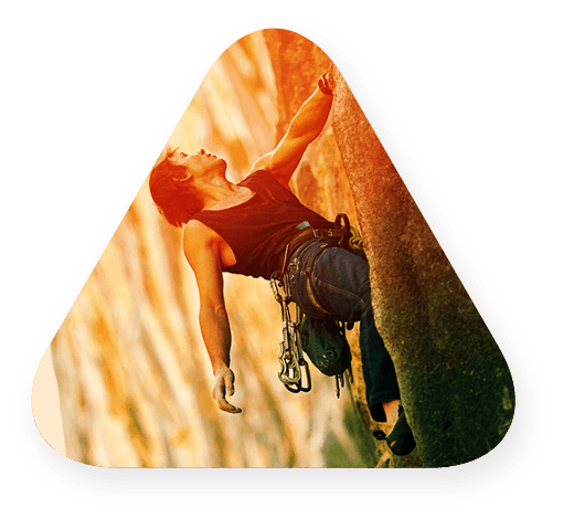 large triangle showing a woman rock climbing in sunlight
