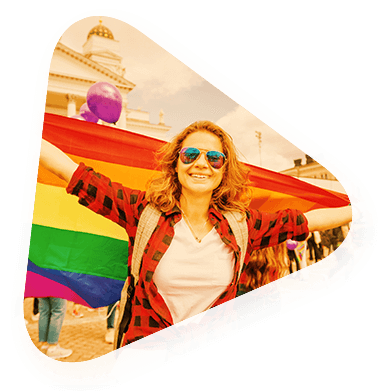 a woman holding up a rainbow flag to celebrate diversity