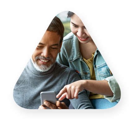 Father, daughter consumers using a mobile phone to review financials 
