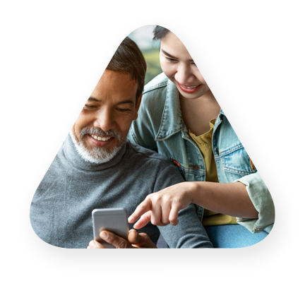 Father, daughter consumers using a mobile phone to review financials