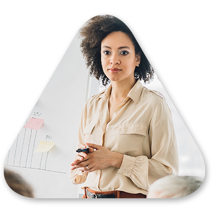 business woman standing in front of a room address colleagues about diversity
