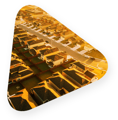 Triangle containing an aerial view of a uniform suburban housing development