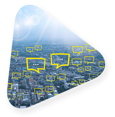 Triangle with a cityscape showing text bubbles pop up over buildings