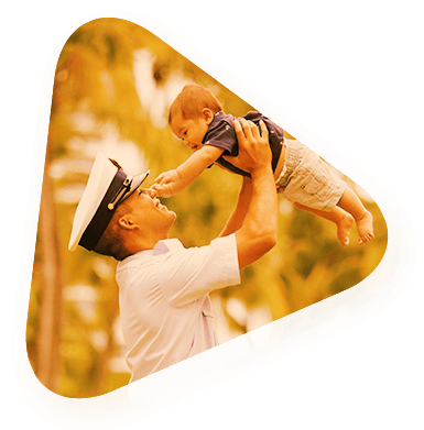 a veteran holding his child up in the air