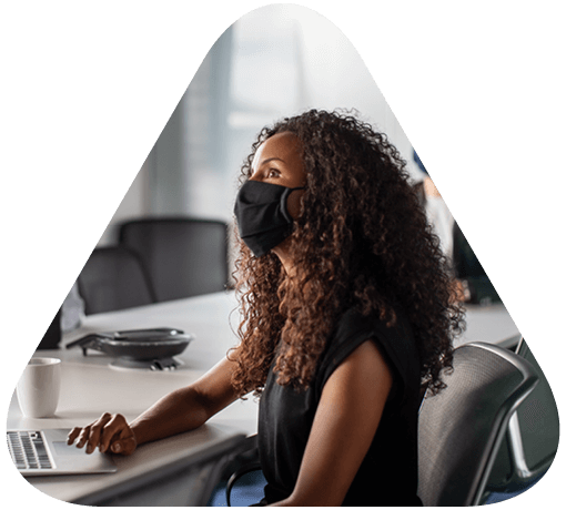 woman in business meeting wearing a mask to prevent the spread of COVID 19
