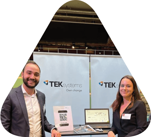 Two people standing at a TEKsystems booth